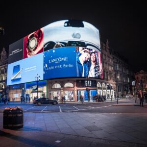 Night view of illuminated billboards at Piccadilly Circus, showcasing vibrant city life in London.
